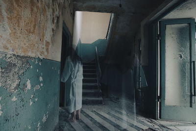 Rear view of man walking in tunnel