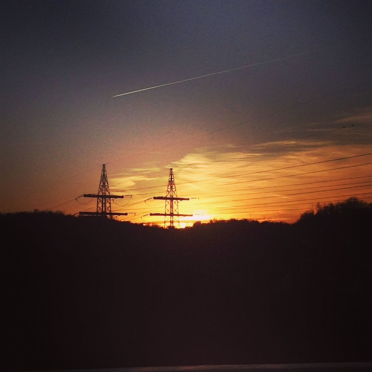 sunset, silhouette, electricity pylon, fuel and power generation, orange color, electricity, power line, tranquility, scenics, tranquil scene, power supply, beauty in nature, sky, landscape, nature, technology, dark, idyllic, low angle view, connection