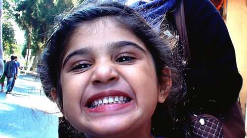 Close-up portrait of smiling girl