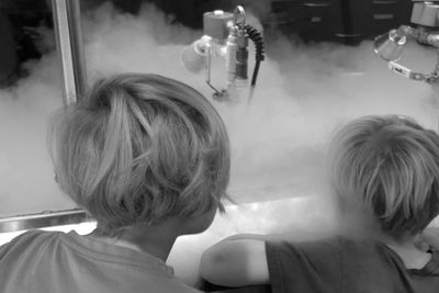 Rear view of mother and daughter at home