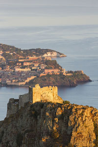 Scenic view of sea and buildings against sky