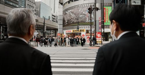 Rear view of man standing in city