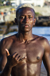 Portrait of shirtless man standing outdoors