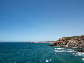 Scenic view of sea against clear blue sky