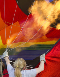 Rear view of woman inflating hot air balloon