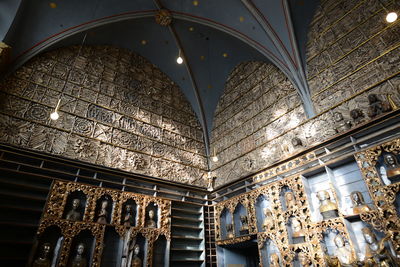 Low angle view of illuminated chandelier in building