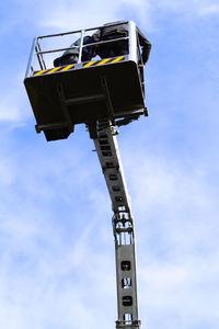 Low angle view of crane against sky
