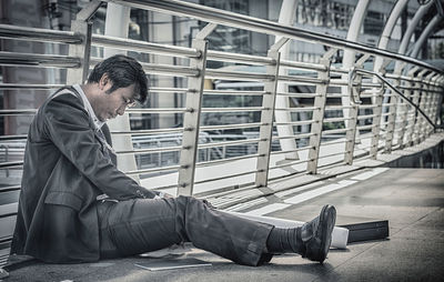 Side view of a man sitting in office