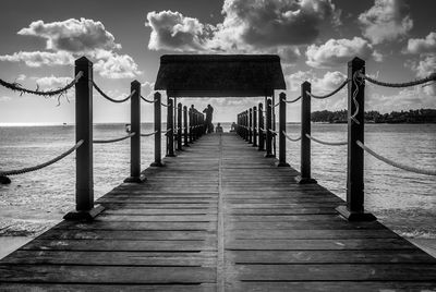 Pier over sea against sky