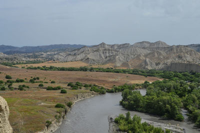 Scenic view of landscape and mountains against sky