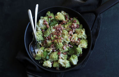 Stir-fried romanesco cauliflower with ham and parmesan.