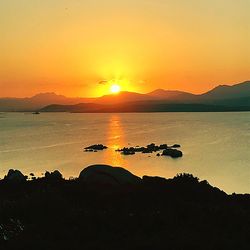 Scenic view of sea against romantic sky at sunset