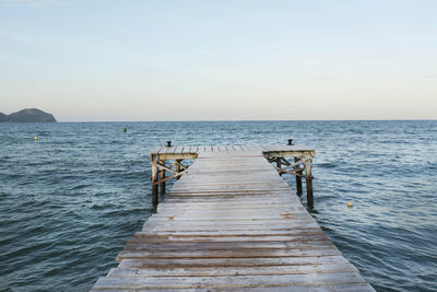 Pier over sea against clear sky