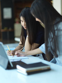 Smiling businesswomen working at office