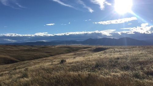 Scenic view of landscape against blue sky