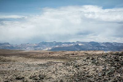 Scenic view of mountains against cloudy sky