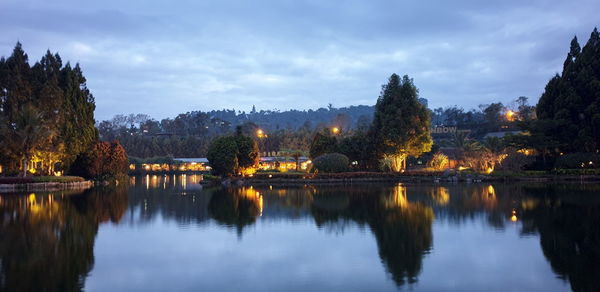 Scenic view of lake against sky at dusk