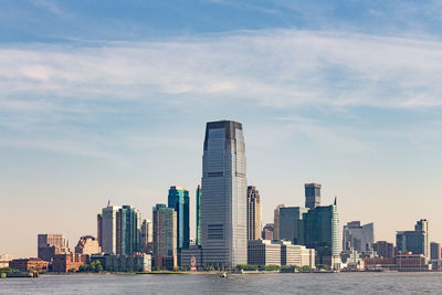 View of skyscrapers against cloudy sky