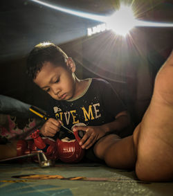 Boy playing with ball on table