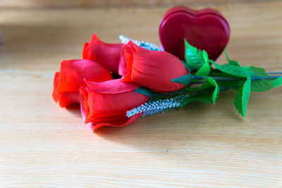 Close-up of red rose on table