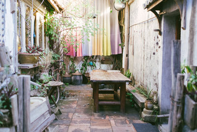 Empty chairs and tables against building