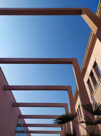 Low angle view of buildings against clear blue sky