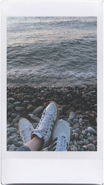 Low section of man lying on shore