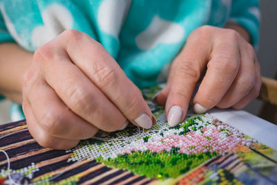 Midsection of man playing jigsaw puzzle