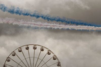 Low angle view of ferris wheel against sky