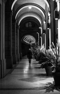 Rear view of woman walking in corridor