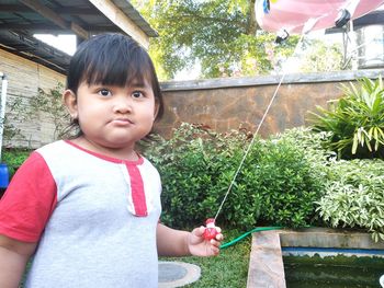 Portrait of cute girl holding plant