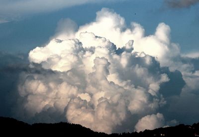 Scenic view of mountains against cloudy sky