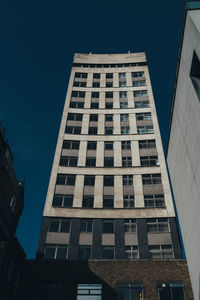 Low angle view of modern building against clear blue sky