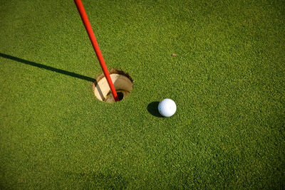 High angle view of golf ball reaching hole