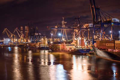 Sailboats in harbor against sky at night