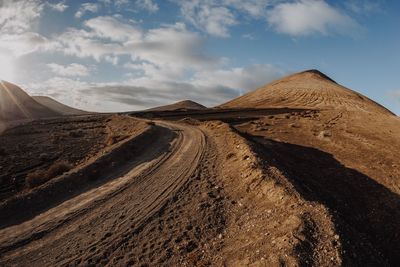 View of desert against cloudy sky