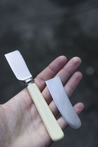 Close-up of person hand holding cigarette