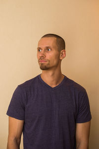 Portrait of mid adult man standing against wall