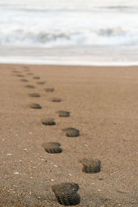 Footprints on sand at beach