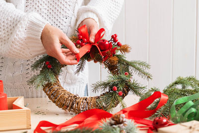 Midsection of woman holding christmas tree