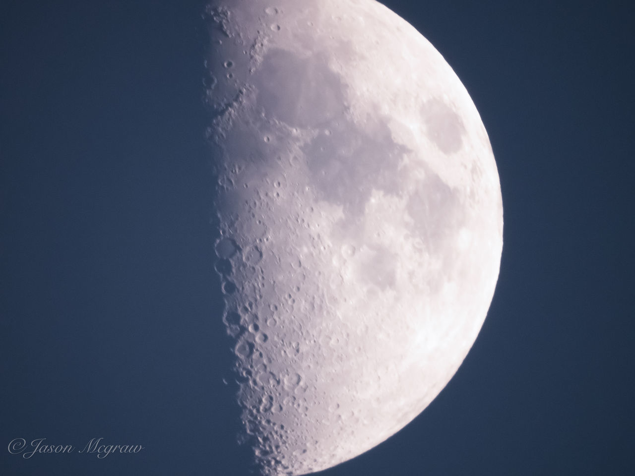 LOW ANGLE VIEW OF HALF MOON AGAINST CLEAR SKY AT NIGHT