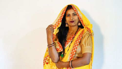 Young woman standing against white background