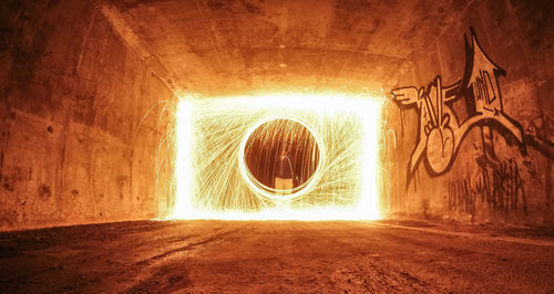 Human hand in illuminated tunnel