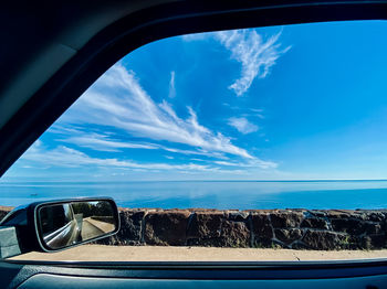 Reflection of sky on side-view mirror