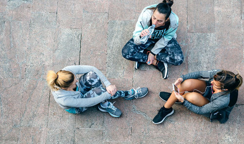 Low section of woman sitting on street