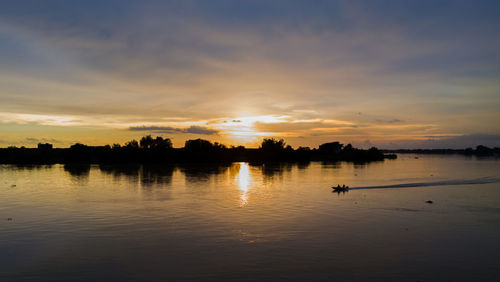 Scenic view of lake against sky during sunset