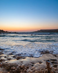 Scenic view of sea against clear sky during sunset