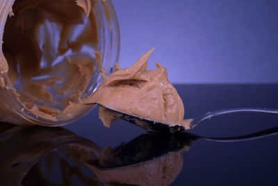 Close-up of ice cream on glass table