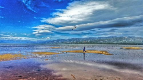 Scenic view of sea against cloudy sky
