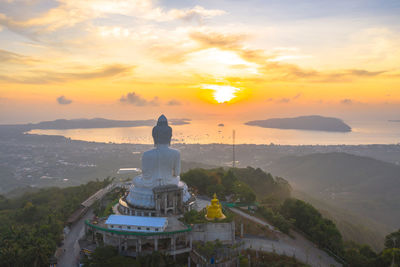 Scenic view of building against sky during sunset